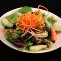 House Salad · Spring mix, tomatoes, cucumber, red onion and carrot served with your choice of Ginger or Pe...