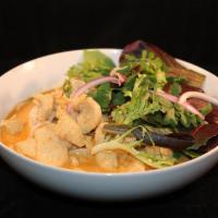 Kaow Soi · Wheat noodles in a mild coconut curry sauce, topped with spring mix, cilantro and red onion.
