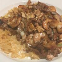 #62 Rice Del Mar · Bed of rice, topped with grilled steak, chicken, and shrimp and topped with our house cheese...
