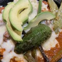 Molcajete · Chicken, steak, and shrimp perfectly cooked with cactus, chorizo, cheese, baby onions, and o...