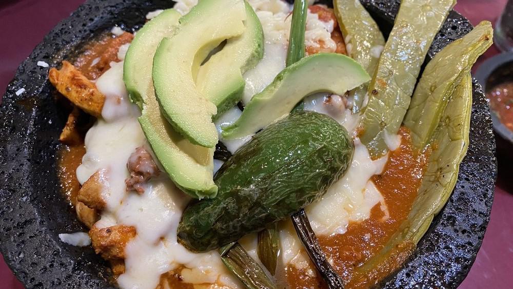 Molcajete · Chicken, steak, and shrimp perfectly cooked with cactus, chorizo, cheese, baby onions, and our special sauce. Delicious and spicy!