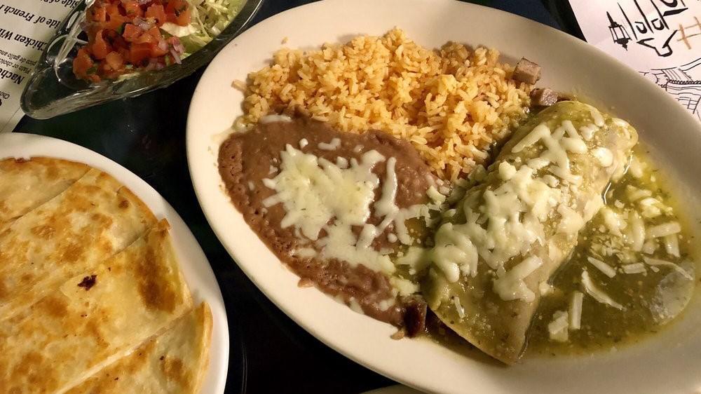 Enchiladas Verdes · Three corn tortillas slightly pan-fried, filled with shredded beef, and topped with salsa verde and cheese.