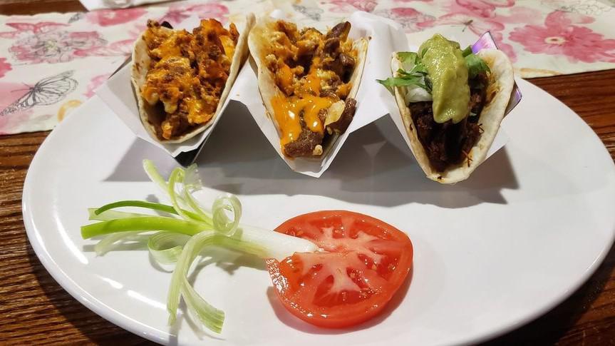 Three Beef Tacos (Crispy) · Tacos filled with ground beef, lettuce, tomatoes, and a blend of cheeses.
