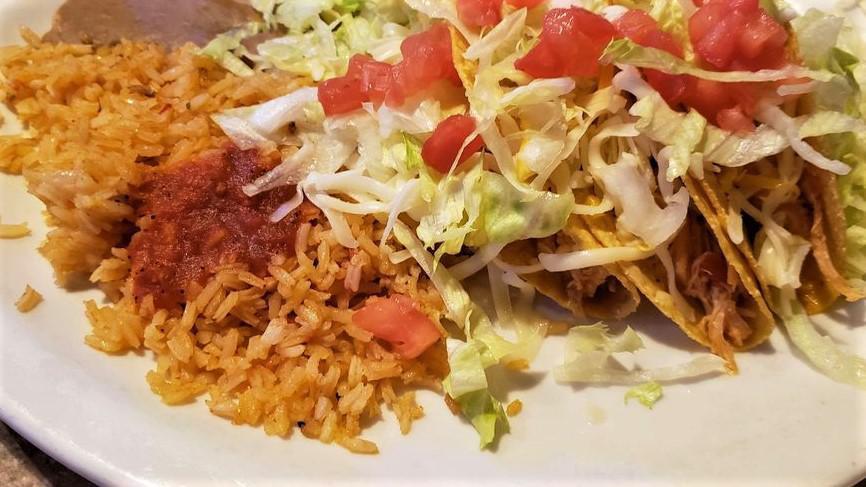 Three Chicken Tacos (Soft) · Tacos filled with chicken, lettuce, tomatoes, and a blend of cheeses.