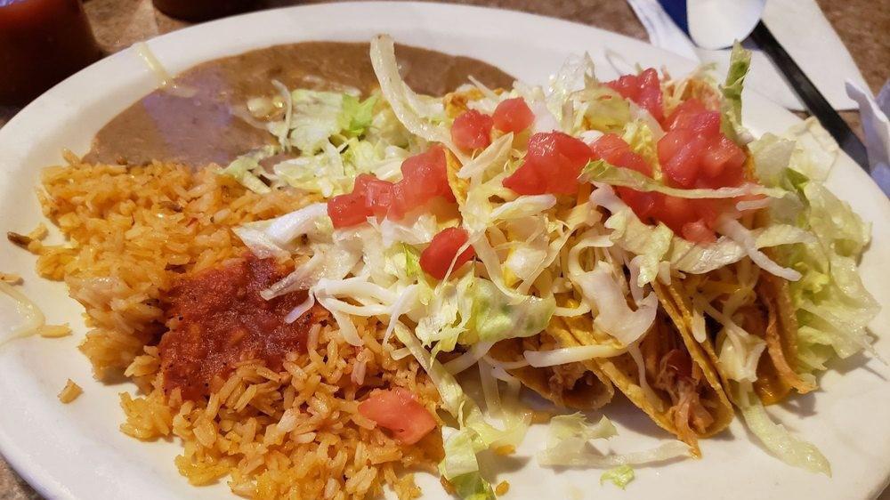 Three Chicken Tacos (Crispy) · Tacos filled with chicken, lettuce, tomatoes, and a blend of cheeses.