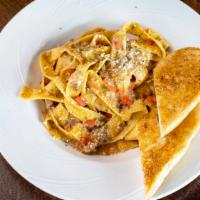 Pappardelle Cream Pasta · Pappardelle pasta with a cream and meat sauce.