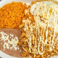 Chilaquiles Con Huevo · Tortilla strips sautéed with green or red sauce. Top with melted cheese & sour cream, chicke...