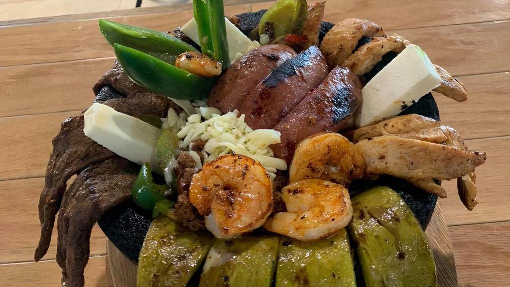 Molcajete · Grilled chicken, carne asada, chorizo, shrimps, cheese, onions, nopales(cactus), bell peppers. Served with rice, beans, salad & tortillas.