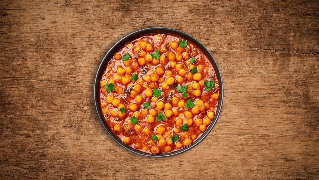 Savory Chickpeas Masala · Chickpeas and diced potatoes cooked in onion and tomato curry with Indian whole spices.