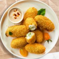 Jalapeño Poppers · Fried jalapeños filled with gooey melty cheese, served with ranch.