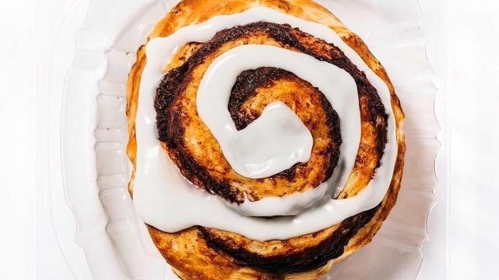 Vanilla Cinnamon Roll · A large, gourmet cinnamon roll made with moist buttery dough and packed with rich, imported cinnamon. Topped with white icing and vanilla drizzle then warmed to perfection.