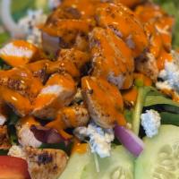 Buffalo Chicken Salad · Blackened Grilled Chicken tossed in Buffalo Sauce, Organic Spring Mix, Cucumber, Tomatoes, R...