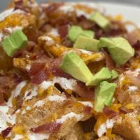 Loaded Pork Skins · House Made Pork Rinds Topped with Shredded Cheddar Cheese, Bacon, Ranch, Avocado.