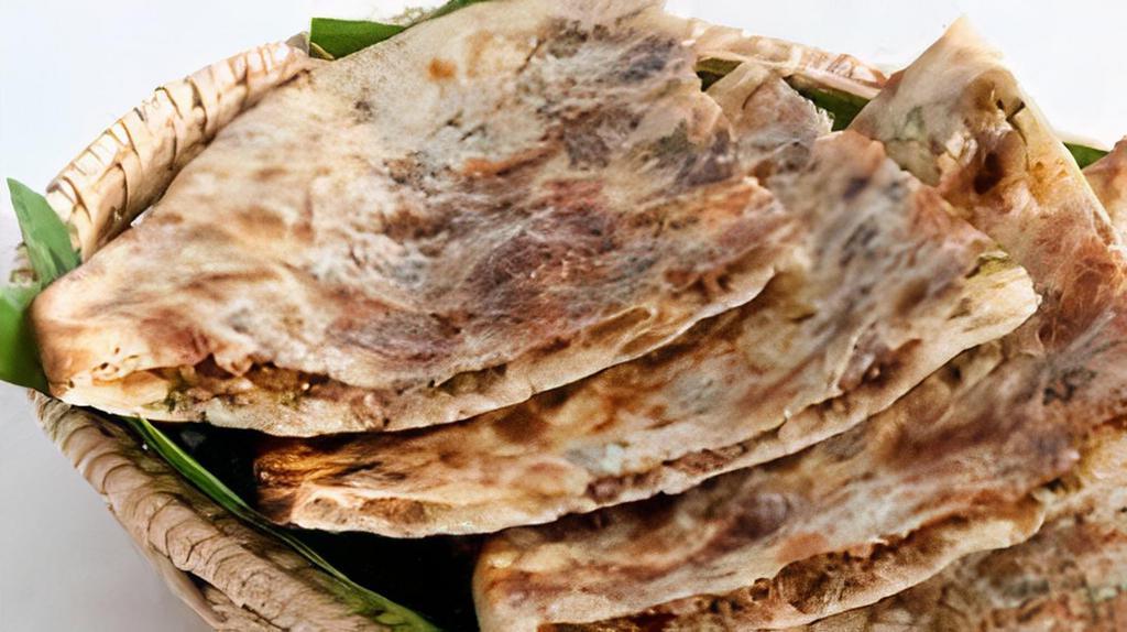 Keema Naan · Multi-layered unleavened white bread stuffed with minced lamb and spices.