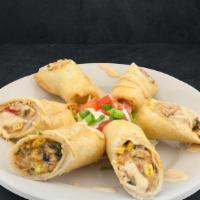 Southwest Egg Rolls · Crispy egg rolls filled with southwest chicken and black bean corn salsa, drizzled with tang...