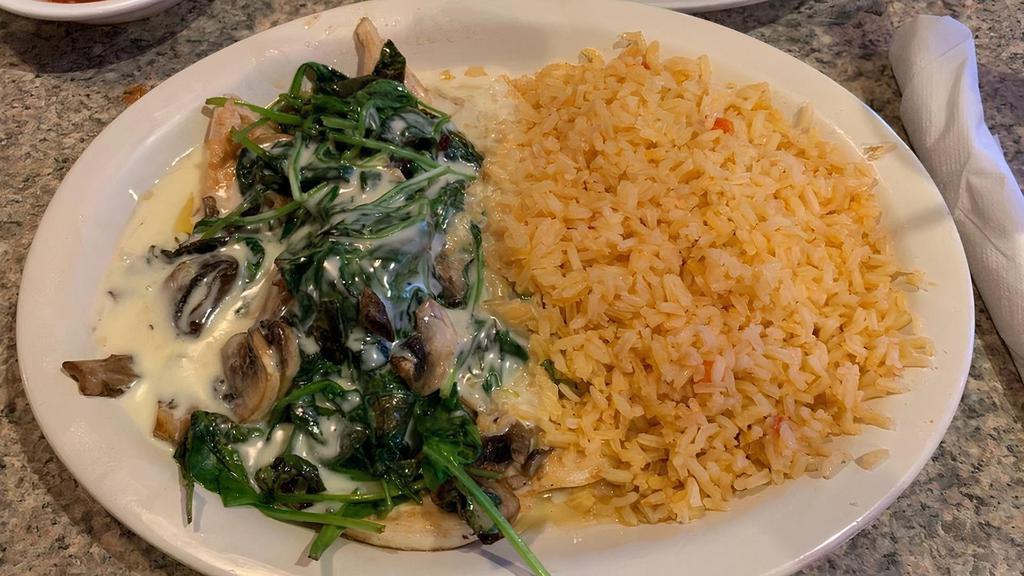 Pollo Tapatio · Grilled and marinated boneless chicken breast covered with fresh-sliced mushrooms, spinach, and onions. Smothered with our special cheese sauce. Served with rice, beans, and tortillas.