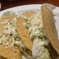 Tacos Santa Ana · Two flour soft tacos filled with sliced steak, cheese dip and lettuce served with rice.