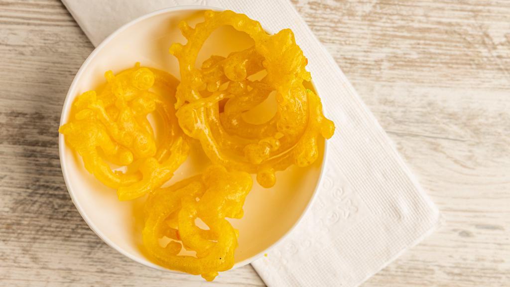 Jalebi · Indian desserts made by deep-frying a wheat flour, batter in pretzel or circular shapes, which are then soaked in sugar syrup.