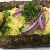 Lamb Kabob · Lamb kabob cooked on open flame to perfection. Served with grilled vegetables and tahini sau...