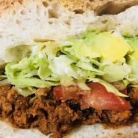 Torta-Mexican Sandwich · Served with mayonnaise, avocado, lettuce, and tomatoes. All between two pieces of hoagie bre...