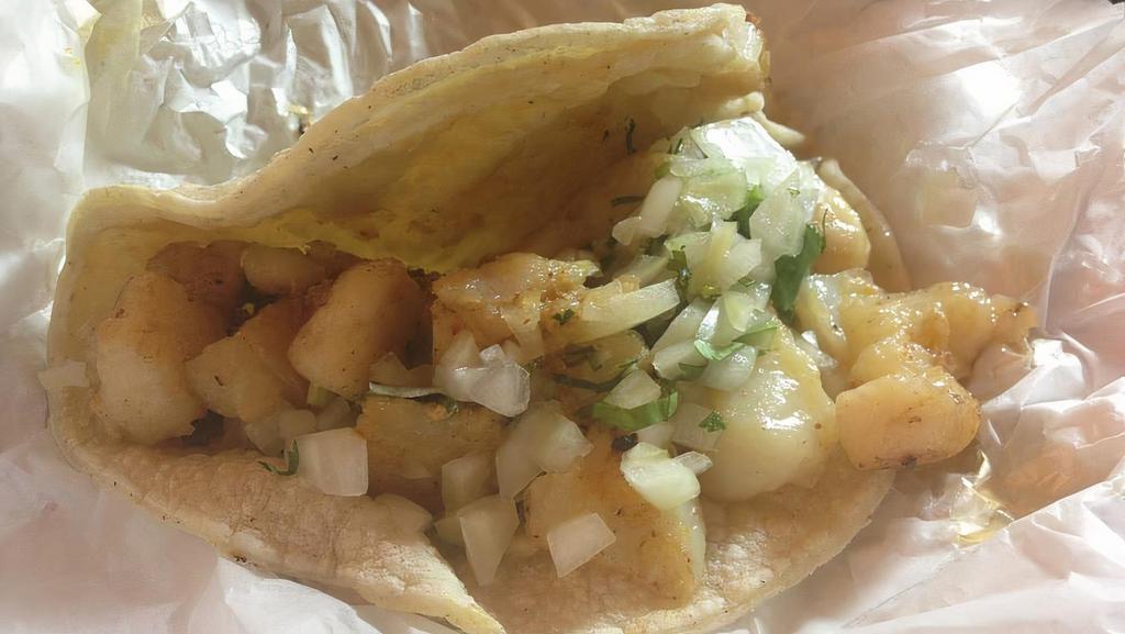 Taco Fish (Pescado) · Served on two soft corn tortillas. Topped with onions and cilantro.