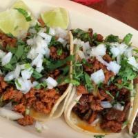 Taco Breakfast (Desayuno) · Served on two soft corn tortillas. Topped with onions and cilantro.