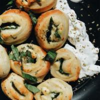 Veggie Knots · Our handmade dough all knotted up and stuffed with fresh spinach and feta cheese. Served wit...