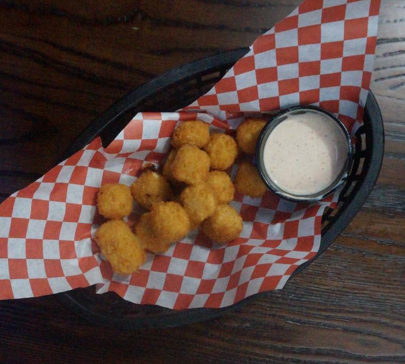 Pepper Jack Cheese Balls · Always the spicy favorite. Bite sized breaded pepper jack cheese balls fried golden brown and served with our homemade spicy ranch.