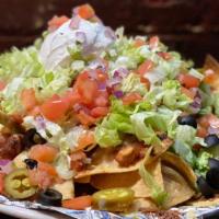 Loaded Nachos · A Mountain of fresh tortilla chips fried to order and covered in our homemade chili and ques...