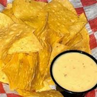 Chips And Queso · Fresh made to order tortilla chips served up with our homemade queso dip.