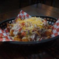 Loaded Tots · A double order of tots covered in homemade chili and queso.  Topped with diced red onion, to...