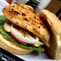 Rajun Cajun Grilled Chicken · Fresh flame grilled chicken breast, Cajun spiced and topped with lettuce, tomato, onion, pic...