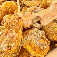 Ranch Fried Pickles Basket · Thinly sliced dill pickle chips lightly battered and fried, tossed in ranch seasoning and se...
