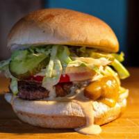 Classic Burger · 1/3 lb. beef burger, melted Cheddar, lettuce, tomato and tangy pickles covered in our homema...