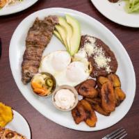 Typical Breakfast · Honduran breakfast served with fried eggs or eggs over easy, chorizo, meat or pork chop, avo...