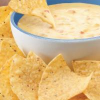 Cheese Dip · Queso blanco with green chilis, cumin, and garlic pepper.
