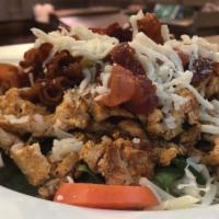 Chicken Salad · Grilled chicken served over a bed of shredded lettuce with baby spinach; topped with shredde...