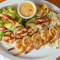 Scallop Kabob · Seasoned and grilled  scallop kabob skewer, served over herb rice and mixed vegetables, dres...