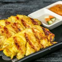 Chicken Satay · Chicken marinated with coconut milk and grilled on skewer. Served with peanut sauce & cucumb...