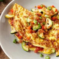 Omelette · Beaten until frothy with onions, spices, and fresh herbs, salt, pepper and cheese served wit...