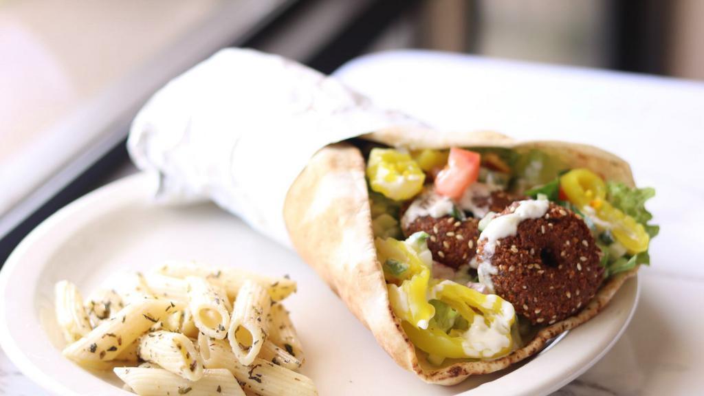 Falafel · Fried ground chickpeas, topped with tomatoes lettuce, cucumber, banana peppers, and hummus.