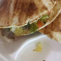 Sicilian Gyro · Gyro meat, provolone cheese, pesto, lettuce, tomatoes, purple onions, and banana peppers.  G...