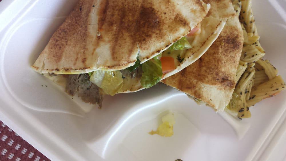 Sicilian Gyro · Gyro meat, provolone cheese, pesto, lettuce, tomatoes, purple onions, and banana peppers.  Grilled to create a crispy pita sandwich.
