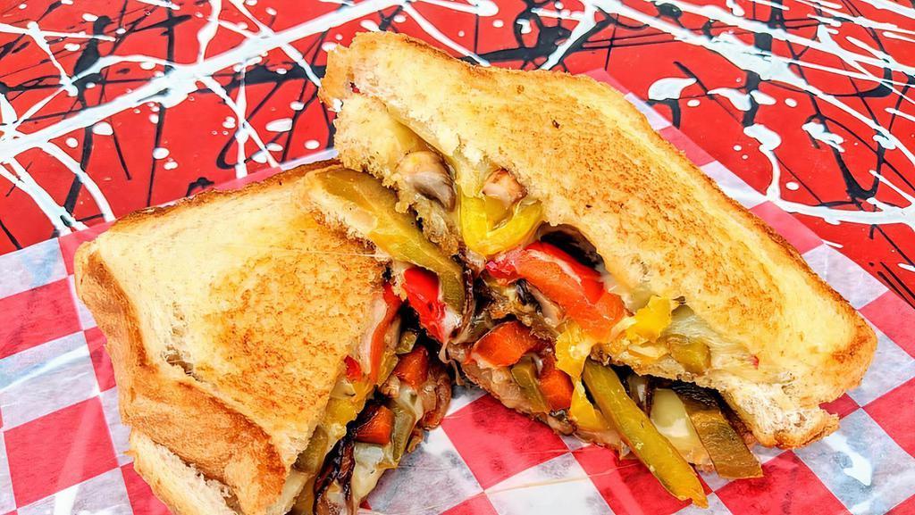 Fire Breathing Veggie · 3 slices of texas toast, stuffed with pepper jack cheese, sautéed mushrooms, grilled onions, sweet peppers and banana peppers