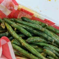 Cast Iron Green Beans · Fresh French style green beans roasted on cast iron and drizzled with yum yum sauce.