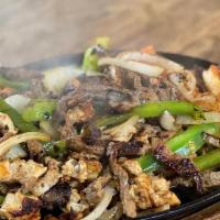 Fajitas Mix · A combination of steak, chicken, shrimp, bell pepper and onion. Served with rice, beans, let...