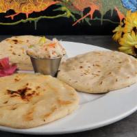 Pupusas · Tortilla pie stuffed with your choice of quesillo, chicharron, refried beans, or a combinati...
