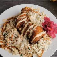 Pollo Con Tajadas · Delicious fried chicken served with green plantains, cabbage salad and our unique pink sauce...