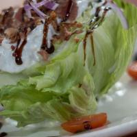 Wedge Salad · 1/4 iceberg lettuce wedge, bleu cheese, bacon, diced tomatoes, red onions, served with a bal...