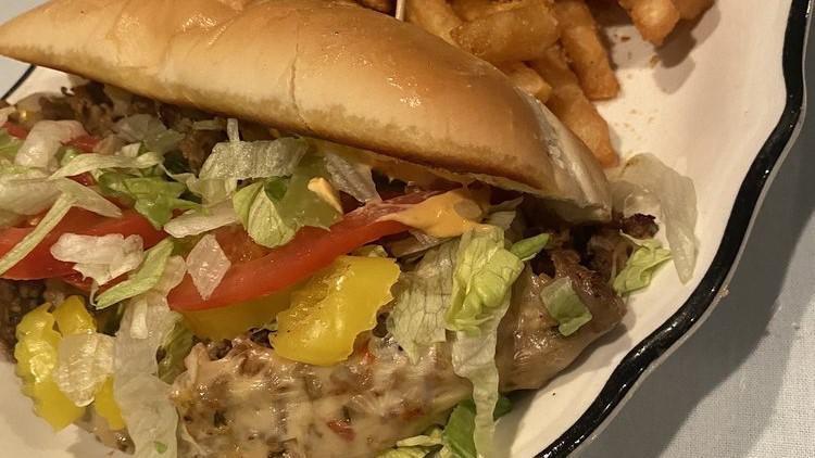 Willy'S Philly (Chicken Or Steak) With Fries · 8 oz. Super sub roll, stuffed with 5 oz of seasoned philly steak or chicken, grilled with red peppers, green peppers, yellow onions, shredded lettuce, sliced red tomato, banana peppers and drizzled with